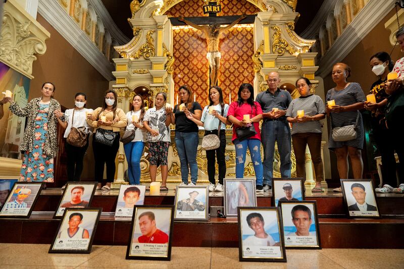 Relatives of victims of drug war and extrajudicial killings gather during a mass, following the arrest of former Philippine President Rodrigo Duterte, in Quezon City, Philippines, March 11, 2025. REUTERS/Lisa Marie David