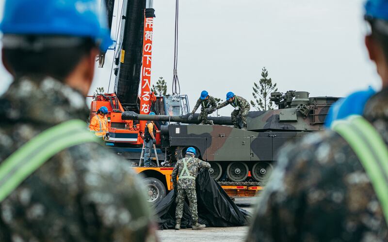 Soldiers securing a US-made M1A2 Abrams battle tank onto a trailer at an army armour training centre in Hsinchu County, Hsinchu on Dec. 16, 2024.