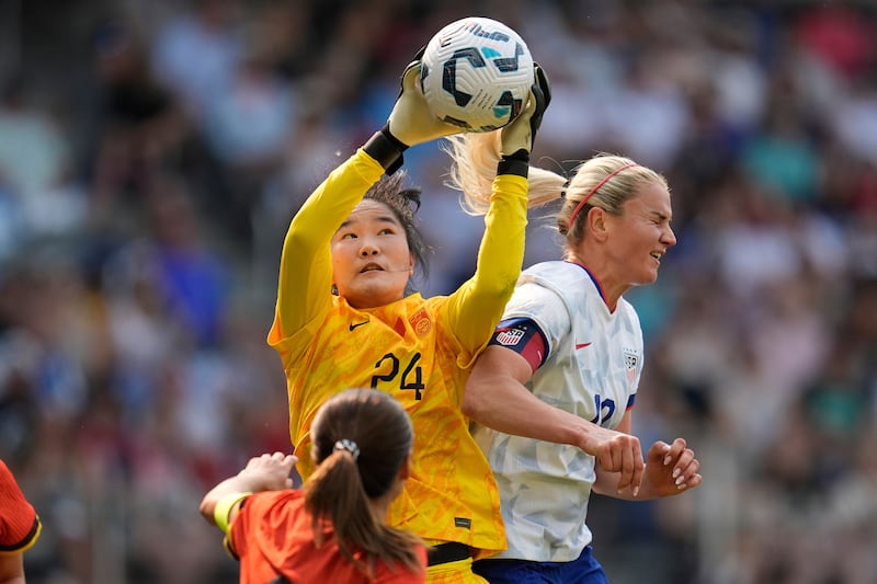 China goalkeeper Pan Hongyan (24) grabs a high ball over United States midfielder Lindsey Heaps (10) during the first half of an international friendly soccer match, May 31, 2025, in St. Paul, Minnesota.