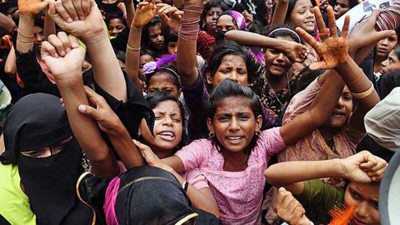 Rohingya refugees shout slogans during a protest march marking the first anniversary of a Myanmar military crackdown that sparked a massive exodus to camps in Bangladesh, at the Kutupalong refugee camp in Ukhia subdistrict, southeastern Bangladesh's Cox's Bazar, Aug. 25, 2018.