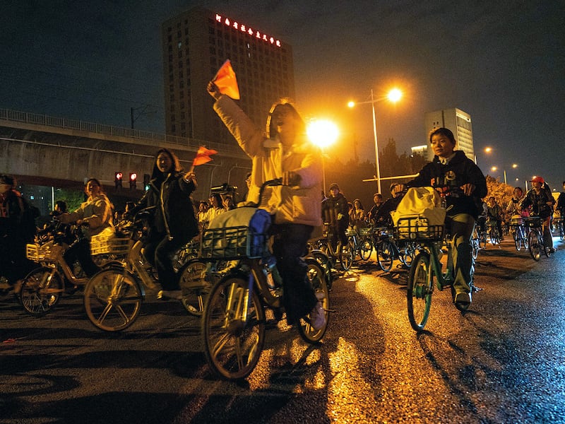 College students ride on on the Zhengkai Road in Zhengzhou, China, to eat dumplings in a nearby city, Nov. 9, 2024.