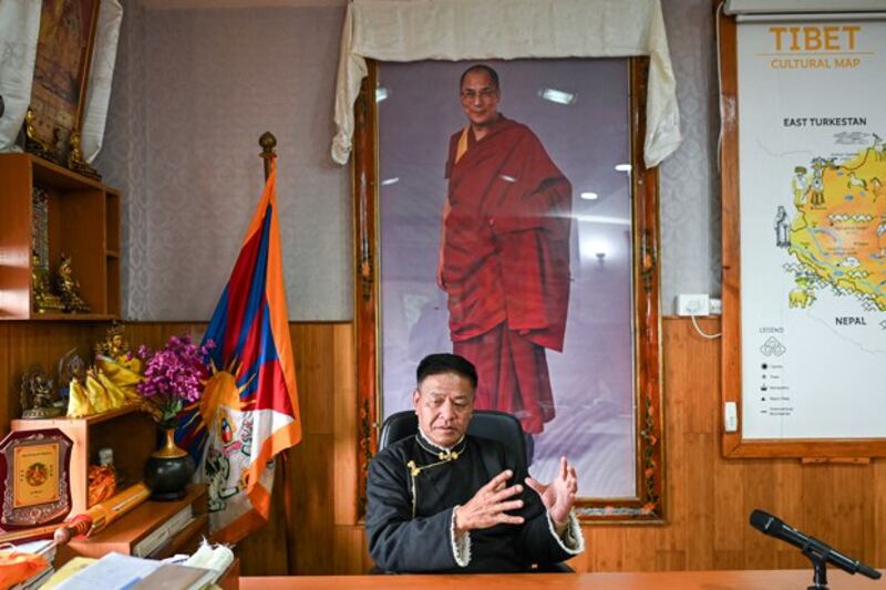 Penpa Tsering, the sikyong or leader of the Tibetan government-in-exile, speaks during an interview with AFP in his office in front of a portrait of the Tibetan Buddhist spiritual leader the Dalai Lama seen in the background, in Dharamsala, India, Feb. 19, 2024. (Sajjad Hussian/AFP)