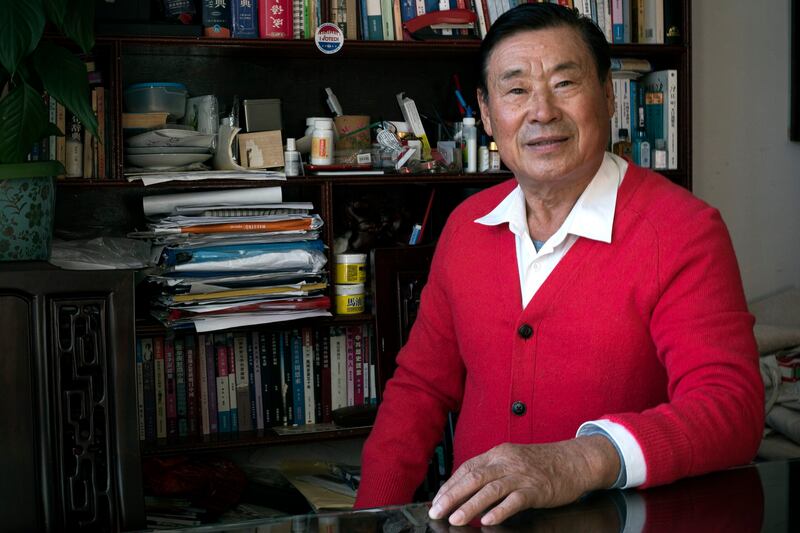 Wang Shujun poses for a photo in his home in Flushing, Queens, in Nov. 2023.