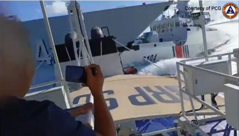 This image made from Aug. 11, 2025 Philippine Coast Guard video shows a collision between a Chinese Navy vessel, left, and a Chinese Coast Guard ship, right, as seen from a Philippine ship near Scarborough Shoal in the disputed South China Sea.