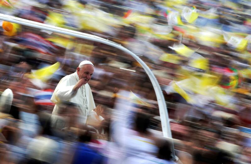 Pope Francis waves as he arrives to lead a mass at Kyite Ka San Football Stadium in Yangon, Myanmar, Nov. 29, 2017.