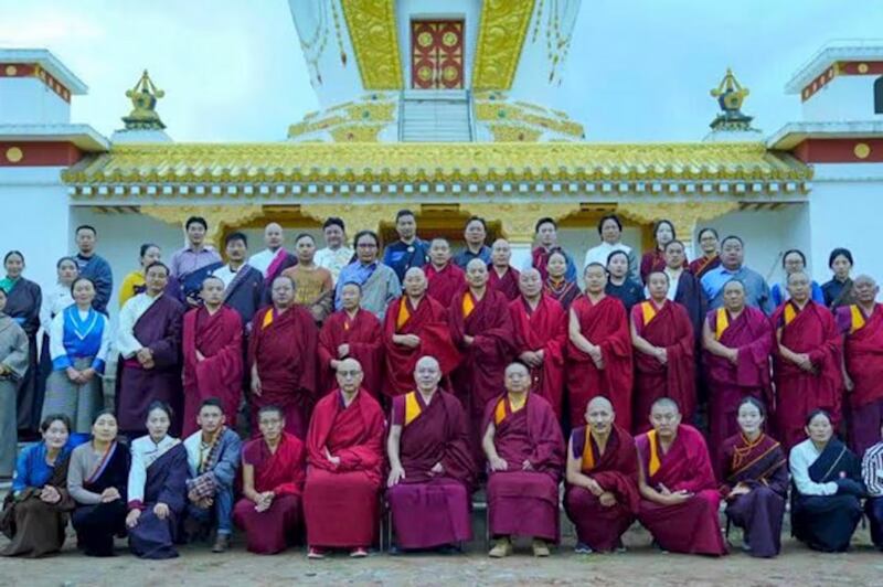 School teachers and staff pose for a group photo outside the Gangjong Sherig Norling school in a Tibetan area of western China's Qinghai province.