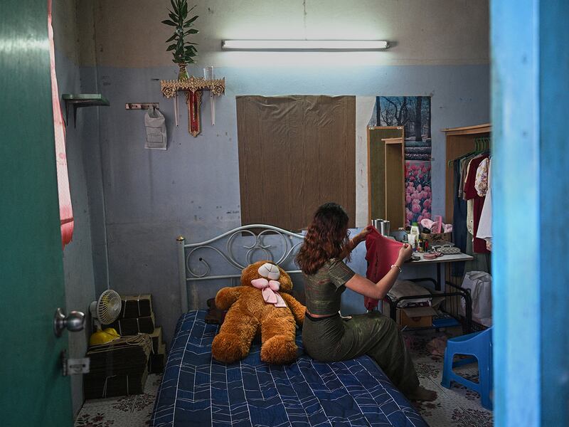 "Khaing," a former teacher with the Civil Disobedience Movement, folds clothes at her current home in Bangkok, Thailand,  June 4, 2024, after fleeing Myanmar to avoid conscription by the military junta.