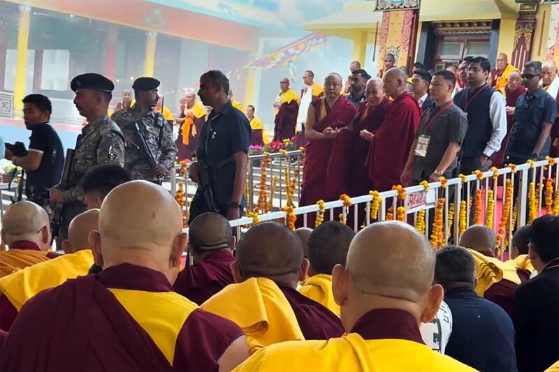 The  Dalai Lama, center, is guarded by the Central Reserve Police Force in Hunsur, Karmataka, India, Feb. 18, 2025.