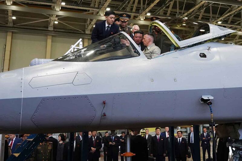 North Korean leader Kim Jong Un looks into the cockpit of a Russian military jet while visiting an aircraft plant in Komsomolsk-on-Amur that builds fighter planes, Sept. 15, 2023. Credit: Khabarovsk Krai region government via AP