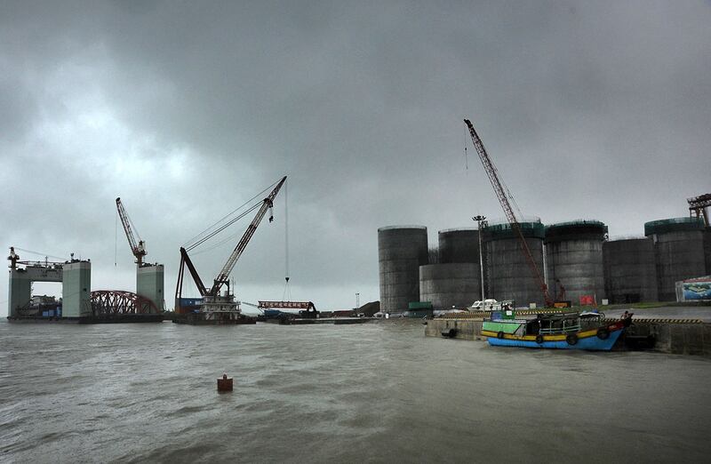 In this June 1, 2012 photo, oil tanks are under construction at a site operated by China National Petroleum Corporation at an offshore block of Madae Island near Kyauk Phyu, Rakhine State, Myanmar. Credit: Lwin Ko Taik/AFP
