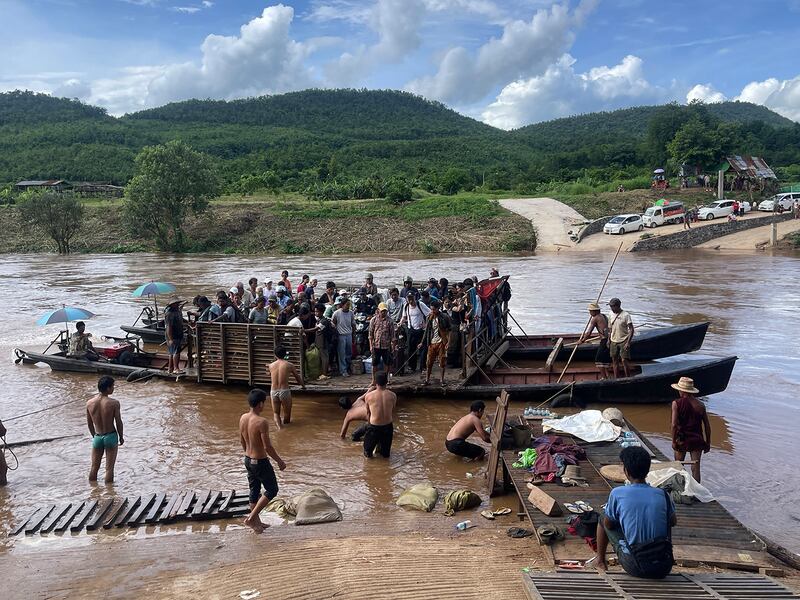 Displaced people from Lashio cross the Dokhtawaddy river as they flee clashes between Myanmar's military and the Ta'ang National Liberation Army, in Myanmar's northern Shan State.
